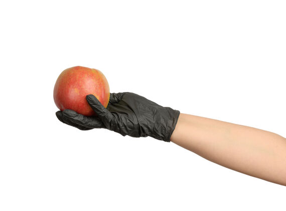 手套戴着黑色乳胶手套的女人手里拿着成熟的红苹果营养女性收获