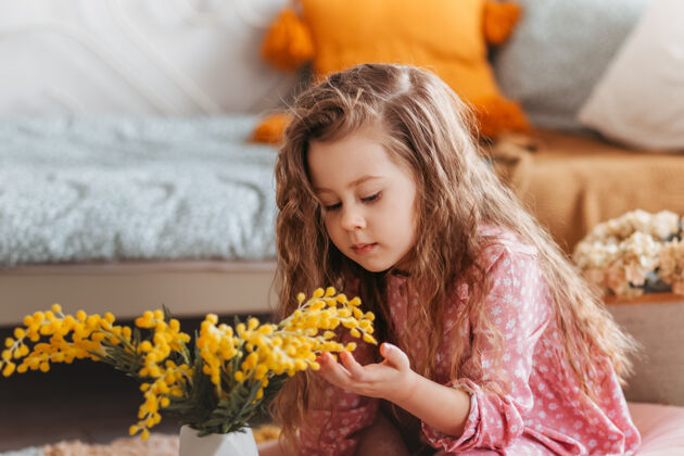 女孩一个可爱的小女孩与含羞草花在儿童卧室的肖像花童年女婴