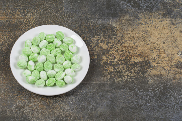 薄荷白色盘子上的绿色薄荷醇糖果邦邦糖果薄荷