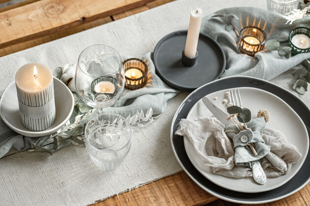 布料节日餐桌的特写细节 包括一套餐具 一个盘子和烛台上的蜡烛摆设蜡烛玻璃