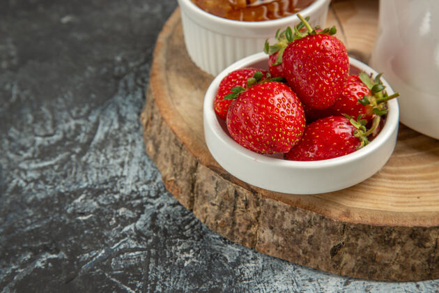 果冻正面图新鲜草莓和蜂蜜在黑暗的表面水果甜果冻农产品甜点可食用水果