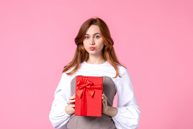 礼品正面图：年轻女性 红色包装 粉色背景 恋爱日期 三月 横向性感礼物 香水 女性照片 金钱平等礼品包装年轻女性