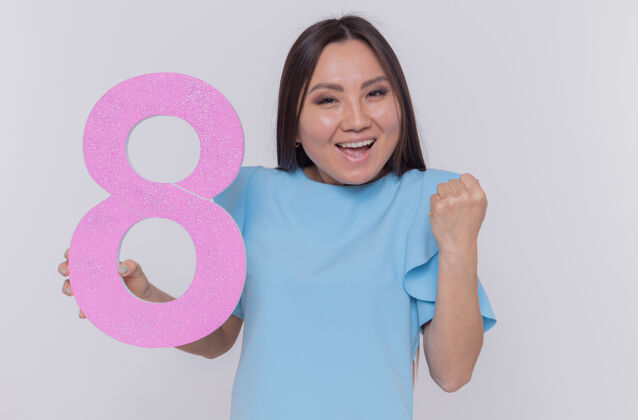 八快乐和兴奋的亚洲女人拿着纸板做的8号天制造庆祝