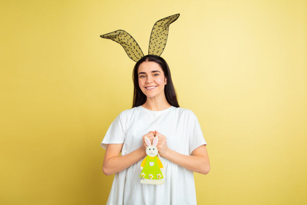 面部黄色墙壁上的复活节兔女郎 情绪亮丽表情明亮兔子