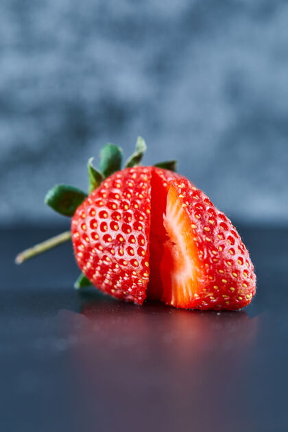 草莓新鲜的红色草莓片在黑暗的表面浆果多汁成熟