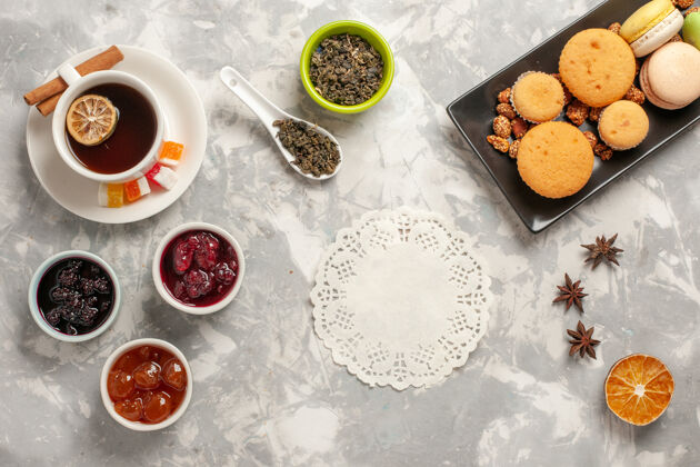 茶顶视图不同的饼干与果酱和一杯茶的白色办公桌饼干糖派蛋糕甜饼干曲奇饼营养品盘子