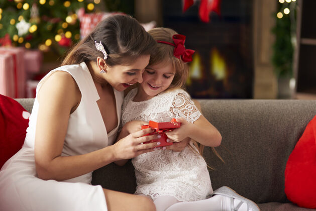 家庭内部女孩和妈妈一起打开圣诞礼盒客厅敬畏圣诞装饰