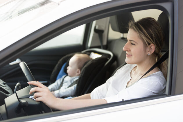 坐着年轻母亲开车的画像 小宝宝坐在前排团结车辆危险