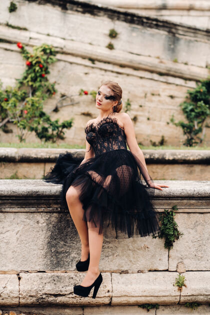 立场一位身着黑色婚纱的时尚新娘在法国古城阿维尼翁摆出姿势法国礼服深情