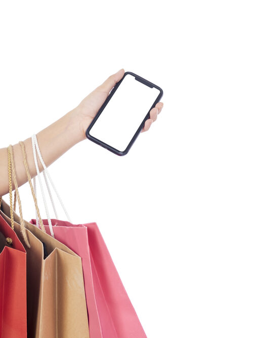 购物拿着白屏智能手机和白墙上购物袋的女人们人空路径