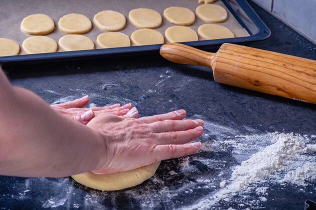 准备女人在家的厨房里准备黄油饼干饼干面团卷