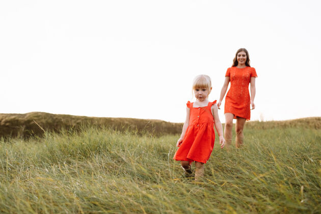 野餐年轻漂亮的妈妈和小女儿在暑假漫步大自然孩子女人春天