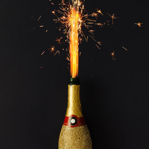 聚会金色香槟派对酒瓶 黑色表面有焰火飞溅瓶子饮料