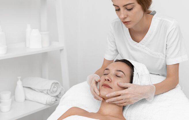 女人美容师为女性客户做美容常规美容护理治疗面部护理
