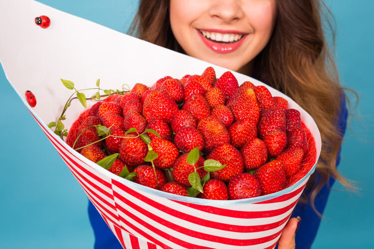 女士拿着一束草莓的年轻女人光明礼品草莓
