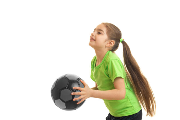 运动一个小女人在玩一个孤立的足球成长球快乐