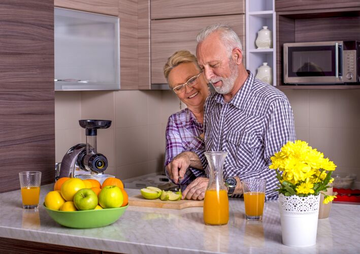 老人美丽的老夫妇在厨房里一起做饭在一起男性祖母