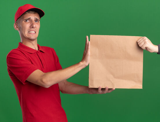 给予焦急的年轻金发送货员把纸包给了别人年轻绿色纸