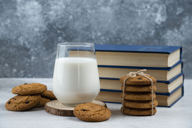 甜点一杯牛奶 甜饼和一本放在大理石桌上的书饼干糕点面包房