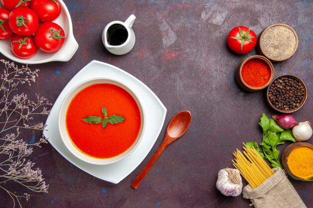 西红柿俯瞰美味的西红柿汤配上新鲜的西红柿和调味料上深色的背景菜一餐酱汁西红柿色汤新鲜汤碗顶部