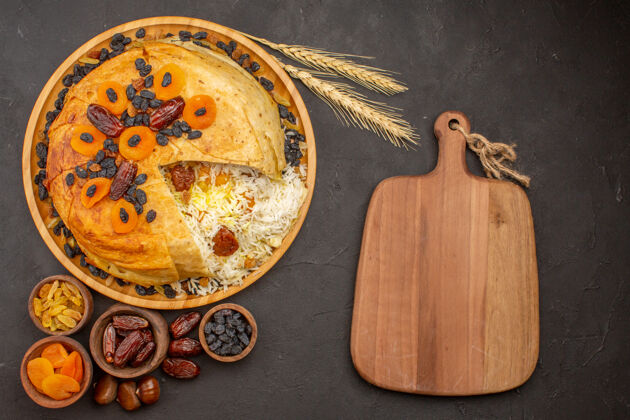 传统灰色表面上有葡萄干和干杏子的美味沙赫普洛夫俯视图一餐大米晚餐