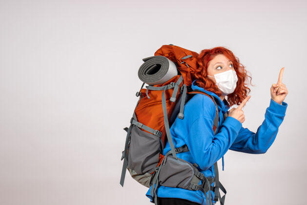 年轻女游客背着背包上山旅游女人颜色背包