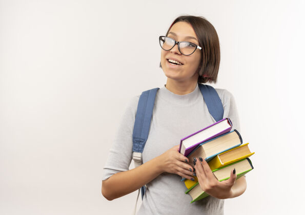 穿快乐的年轻女学生戴着眼镜 背着书包 望着白纸上孤零零的一面年轻包壁板