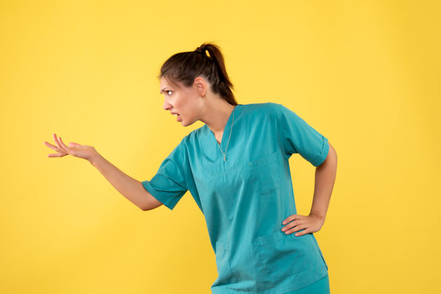 休闲前视图黄色背景上穿着医用衬衫的女医生衬衫医疗女医生