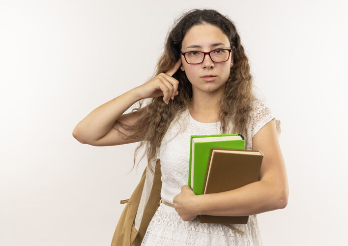 眼镜自信的年轻漂亮的女学生戴着眼镜背着书包把手指放在耳朵上隔离在白色上戴女生抱