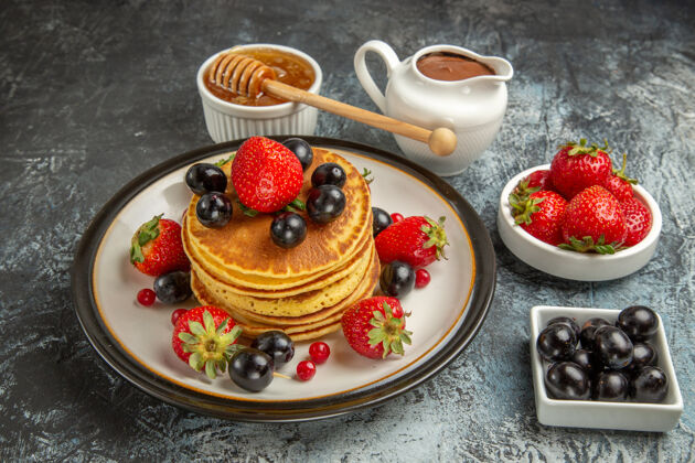 草莓正面是美味的薄饼 上面有蜂蜜和水果 还有甜甜的水果蛋糕蛋糕营养素前面