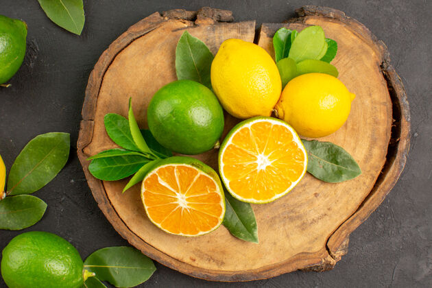 食物顶视图新鲜酸柠檬上深色水果柑橘酸橙深色柠檬健康
