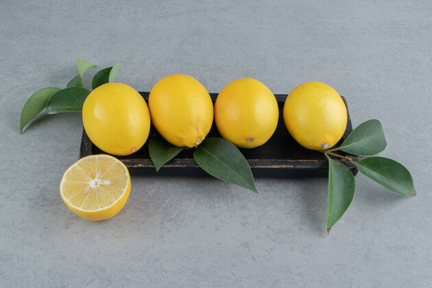 柠檬柠檬放在一个小托盘上 上面装饰着大理石上的叶子新鲜配料美味