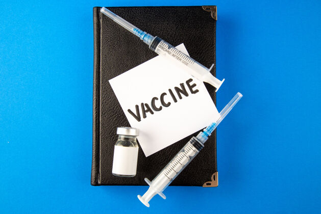 活页夹顶视图抗病毒注射与文案和疫苗的蓝色表面病毒医学医院药物科维-实验室治疗健康药品医院疫苗