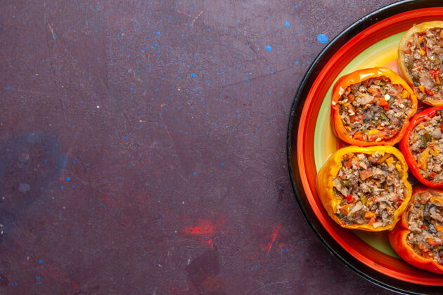 甜椒上图：深灰色背景上的熟肉甜椒配牛肉多尔玛蔬菜套餐用餐午餐视图