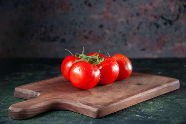 一餐前视图新鲜的红色西红柿在砧板上深色的背景新鲜深色浆果