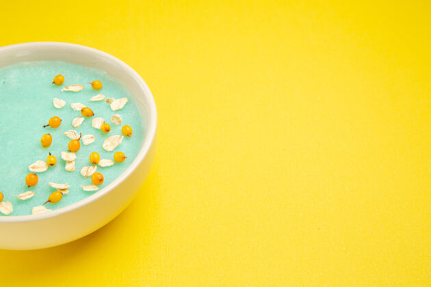 里面前视图蓝色冰镇甜点在浅黄的餐桌上 牛奶麦片颜色餐菜肴光