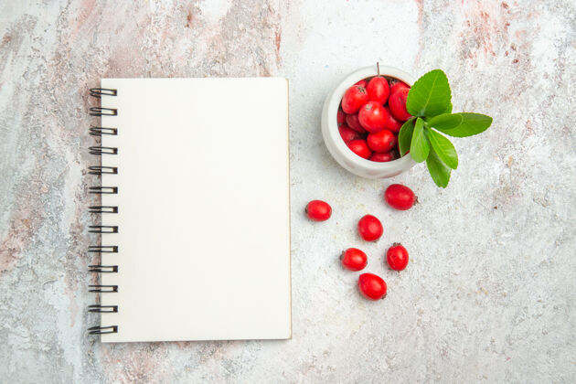 图钉在白色桌面上俯瞰红色水果浆果红色水果红色水果冬青水果