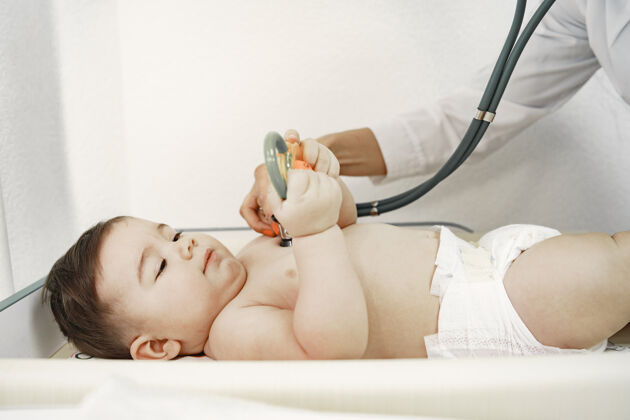 医生医生带听诊器婴儿不穿衣服医生检查评级听诊器诊断