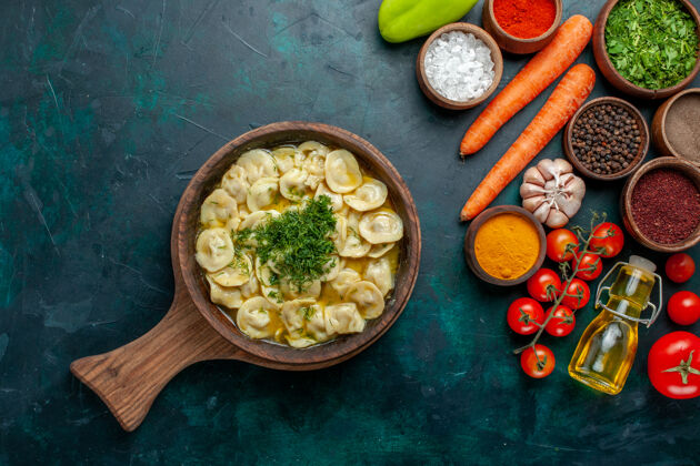 勺子俯瞰美味的水饺配上蔬菜和不同的调味料 上深绿色的墙面 上餐食品配料产品面团肉蔬菜晚餐晚餐
