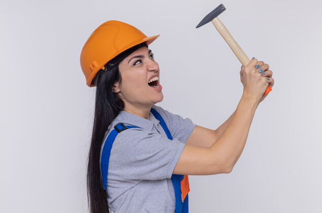 年轻穿着施工制服和安全帽的年轻建筑工人摇摆女人制服
