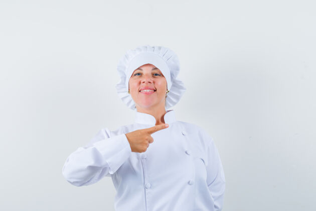 女人穿着白色制服的女厨师指着右边 看上去很自信女性自信时尚