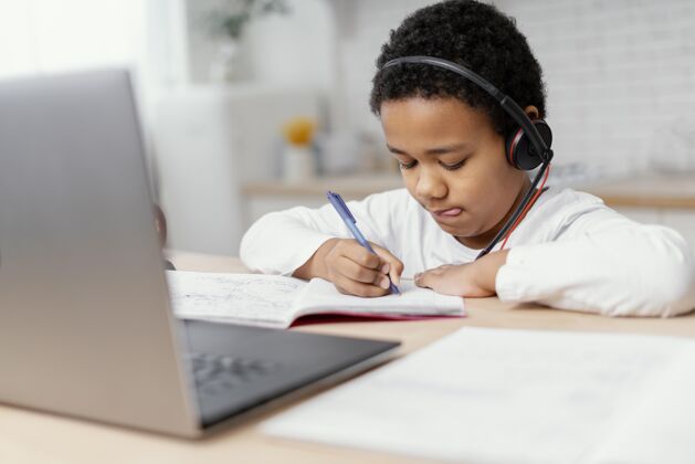 钢笔男孩用笔记本做作业技术笔记本电脑写字