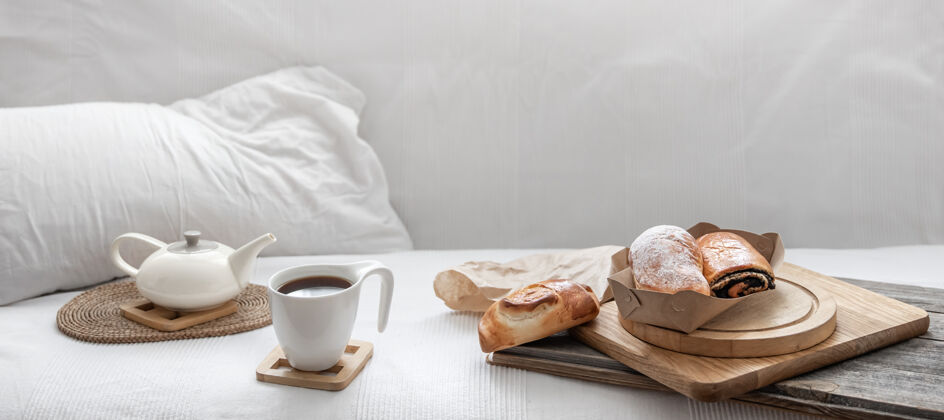 早午餐新鲜的糕点和一杯咖啡在白色的床上早午餐和周末的概念甜食成分早餐