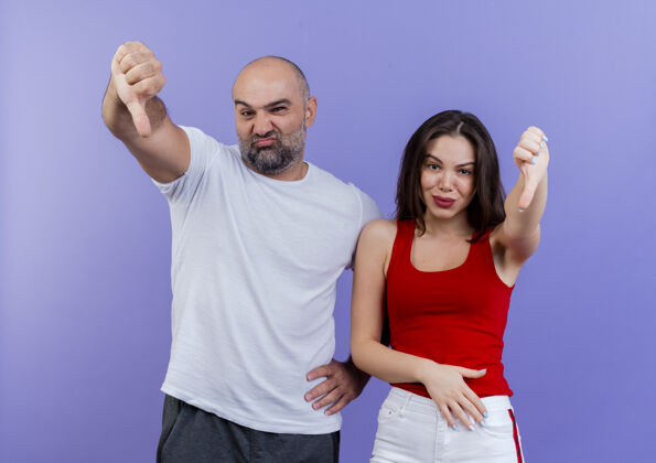 男人未出租的成年夫妇 男人手放在腰上 女人手放在肚子上 两眼望着 拇指朝下腰部向下显示