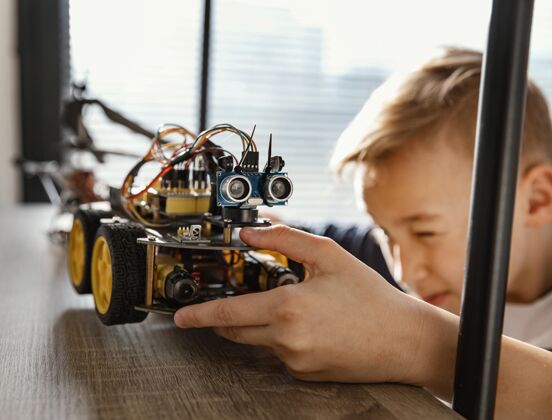 孩子男孩在架子上放机器人组件建筑工具男孩