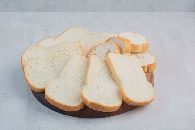 食品大理石背景上的新鲜白面包片面包房小吃切片