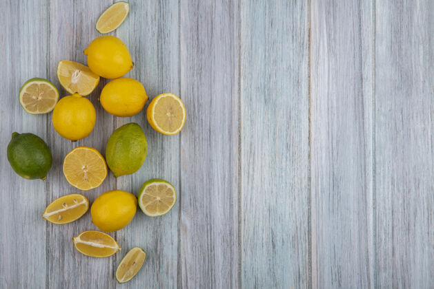 食物顶视图复制空间柠檬与石灰和楔形灰色背景顶部酸橙柑橘