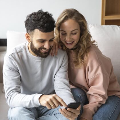 男人笑脸夫妇在家智能手机浪漫女人女朋友