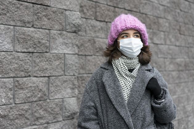 人戴着医用口罩的女人在城市里有复印空间人类流行病安全