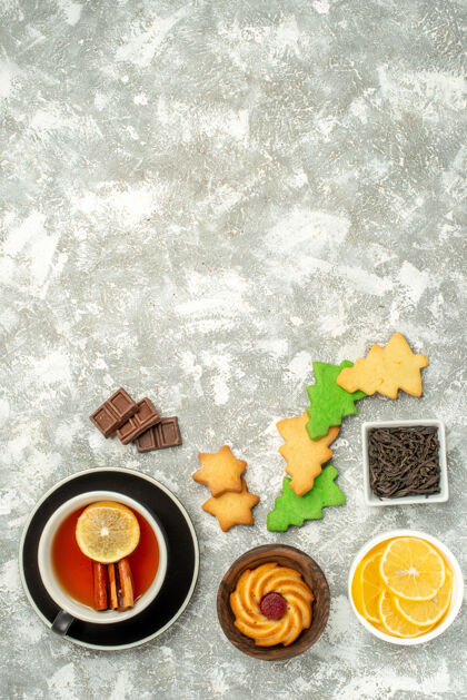 茶顶视图圣诞树饼干一杯茶碗与巧克力和柠檬片在灰色的表复制空间碗圣诞饼干树切片
